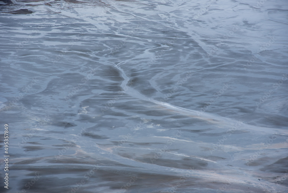 Muddy waters in a decantation pond. Toxic residuals from a copper mine decating in a settling basin Muddy waters in a decantation pond. Toxic residuals from a copper mine decating in a settling basin