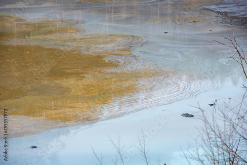 Muddy waters in a decantation pond. Toxic residuals from a copper mine decating in a settling basin