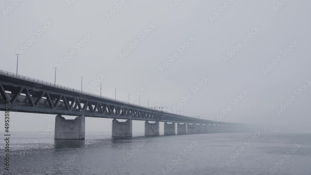 Train passing by on the Oresund bridge between Sweden and Denmark on a foggy day. Train passing by on the Oresund bridge between Sweden and Denmark on a foggy day.