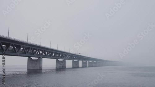 Train passing by on the Oresund bridge between Sweden and Denmark on a foggy day. photo