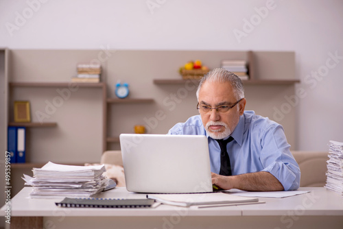 Old male boss working from home during pandemic