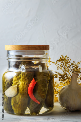 Pickled cucumbers in a jar.