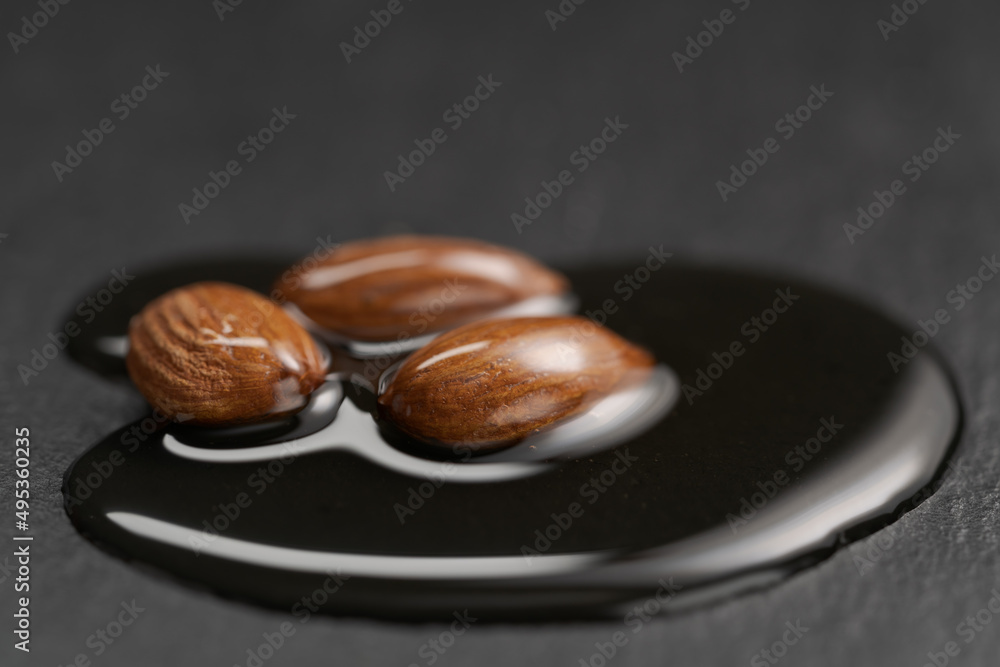 Almonds with honey on slate background