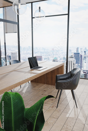 3D Rendering : illustration of modern interior Creative designer office desktop with laptop computer. mock up working place. wood table. light from outside. loft wooden floor background. glass window.