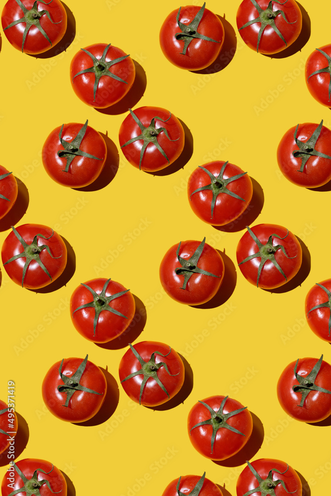 red tomatoes pattern on yellow background. Flat lay, top view. Summer concept. Vegan and vegetarian diet. Seamless Pattern with tomatoes red tomatoes pattern on yellow background. Flat lay, top view. Summer concept. Vegan and vegetarian diet. Seamless Pattern with tomatoes