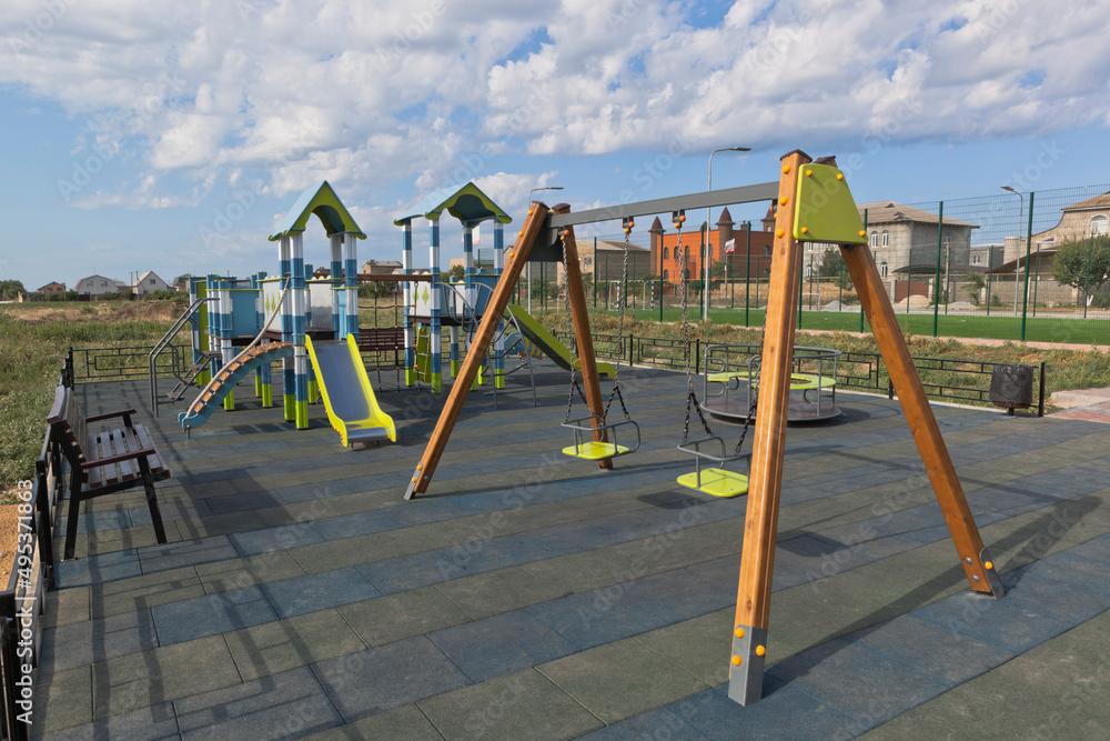 Fototapeta premium Swings on the playground along Kirov street in the village of Uyutnoye, Saksky district, Evpatoria, Crimea
