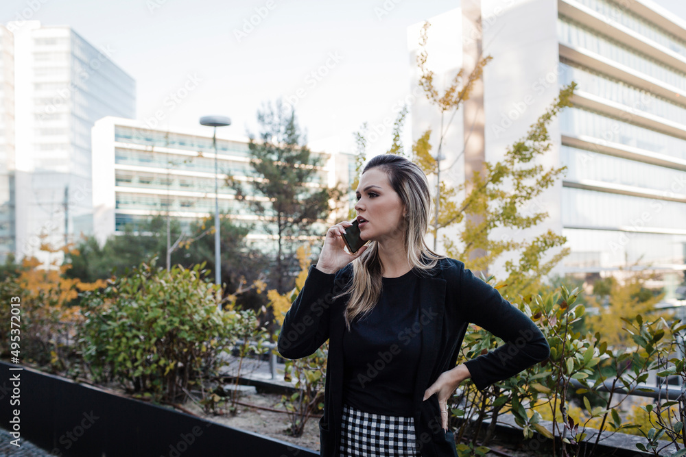 Businesswoman talking on smart phone in city Businesswoman talking on smart phone in city
