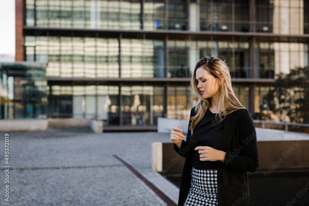 Contemplative businesswoman standing on footpath Contemplative businesswoman standing on footpath