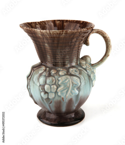 Ceramic jug or vase isolated on white background. Retro pitcher with relief decoration.