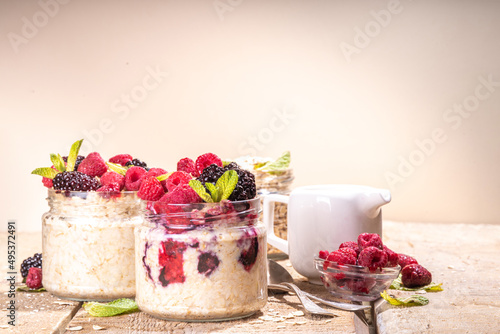 Healthy Homemade Overnight Oats Oatmeal with berry. Portioned Oatmeal with fresh raspberry ans blackberry in a glass jar. Healthy summer breakfast © ricka_kinamoto