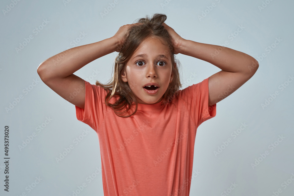 Scared little girl with open mouth grab her hair Scared little girl with open mouth grab her hair