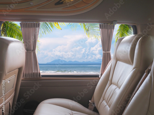 Empty brown leather seats in van over summer beach background. © pkanchana