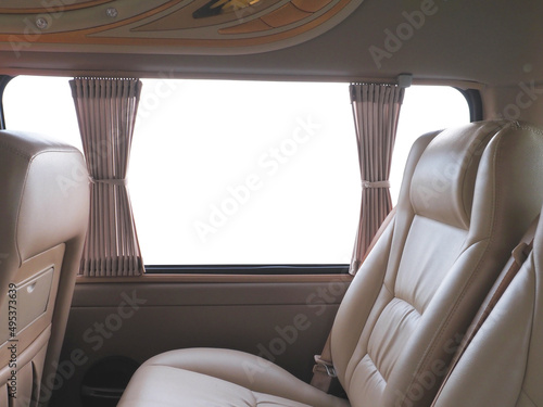 Empty brown leather seats in van over white background. © pkanchana