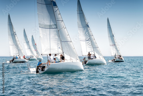 Sailing boats on the start line of regatta