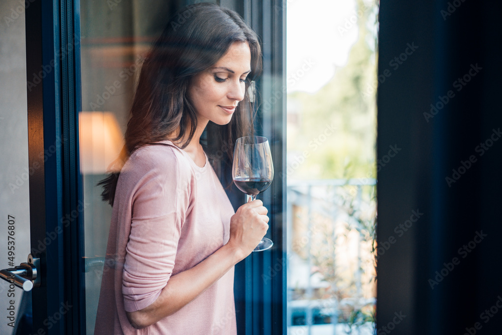 Beautiful woman with wineglass seen through glass window Beautiful woman with wineglass seen through glass window