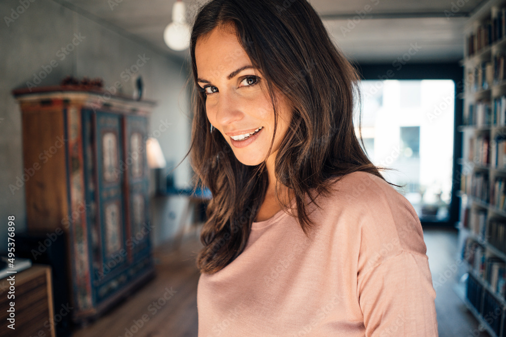 Smiling beautiful woman with brown hair at home Smiling beautiful woman with brown hair at home