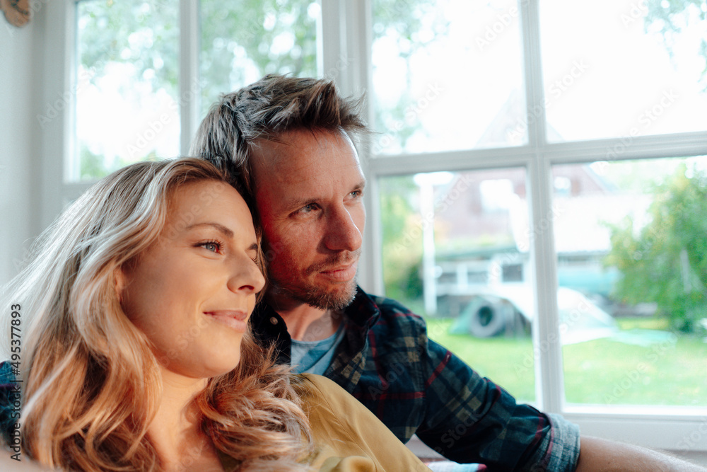 Smiling blond woman with boyfriend at home Smiling blond woman with boyfriend at home