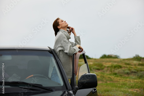 beautiful woman with red hair in a sweater near the car nature female relaxing