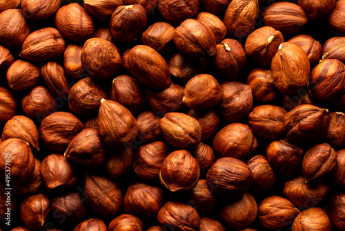 Peeled hazelnuts on a white wooden background. Isolate. photo