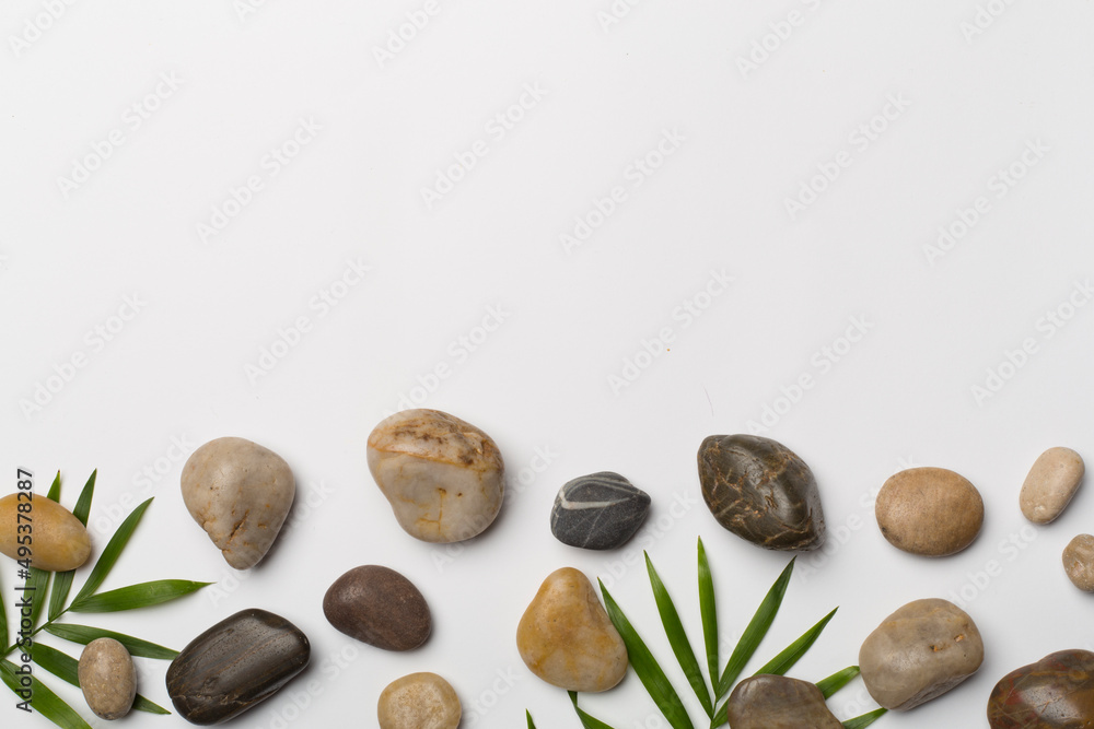 Spa stones and leaves on wooden background, top view Spa stones and leaves on wooden background, top view