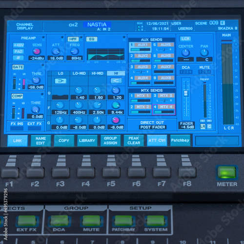 Modern digital mixing console with faders, control buttons and touch screen. Selective focus