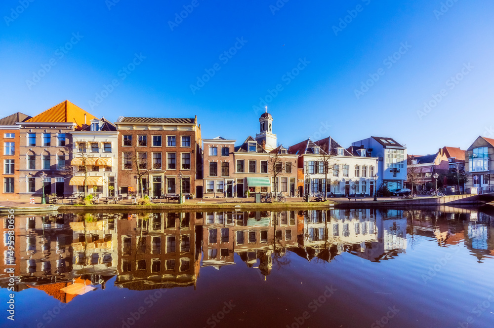 Netherlands, South Holland, Leiden, Row of townhouses reflecting in city canal Netherlands, South Holland, Leiden, Row of townhouses reflecting in city canal