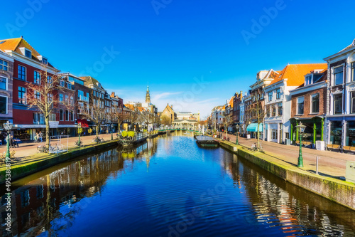 Netherlands, South Holland, Leiden, Rows of townhouses standing along city canal photo