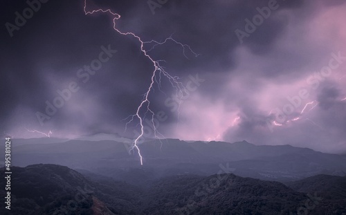 mountains and dark clouds with thunderstorm and lightening.