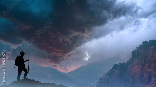 Success achievement concept. Silhouette of person standing on top of mountain.