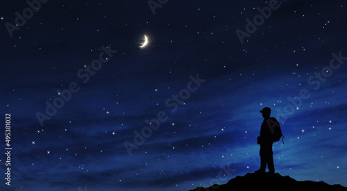 Success achievement concept. Silhouette of person standing on top of mountain at night