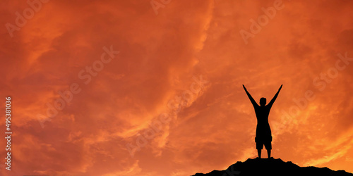 Success achievement concept.. Silhouette of a happy person in the sky.