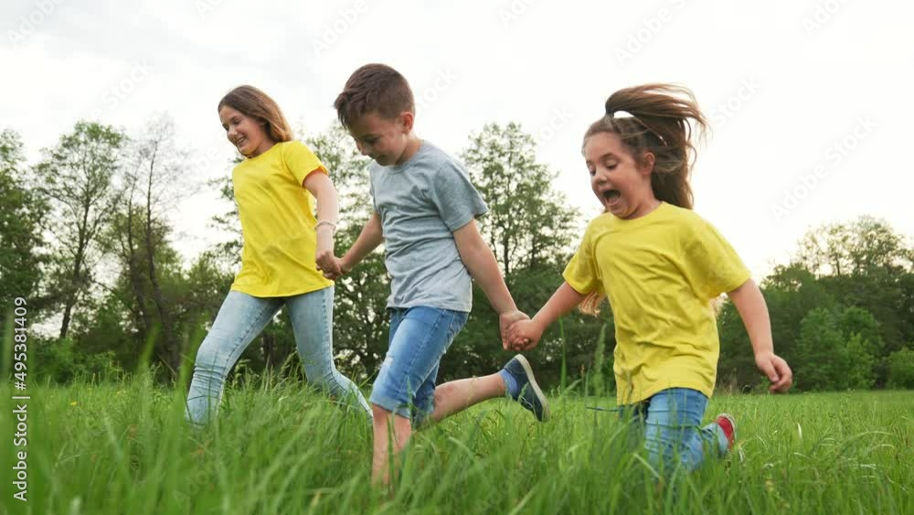 Young team of children. Group of children run in park on grass. Team play in park. Teamwork concept Children run on green grass. Kids team run in park. Kids play in natural park.Group of kids teamwork Young team of children. Group of children run in park on grass. Team play in park. Teamwork concept Children run on green grass. Kids team run in park. Kids play in natural park.Group of kids teamwork