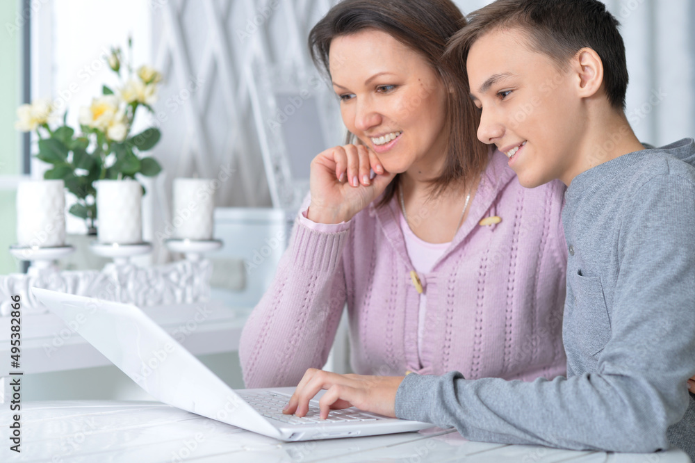 Emotional mother and son using modern laptop Emotional mother and son using modern laptop
