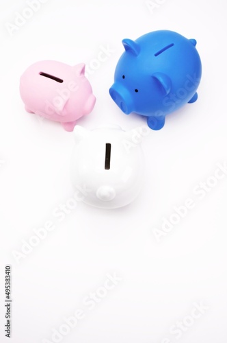 Business and Finance concept - Piggy Banks viewed from above on a white table surface with space for text 