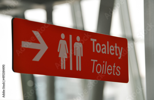 Sign indicating the place of the toilets inside the Warsaw Airport in Poland.