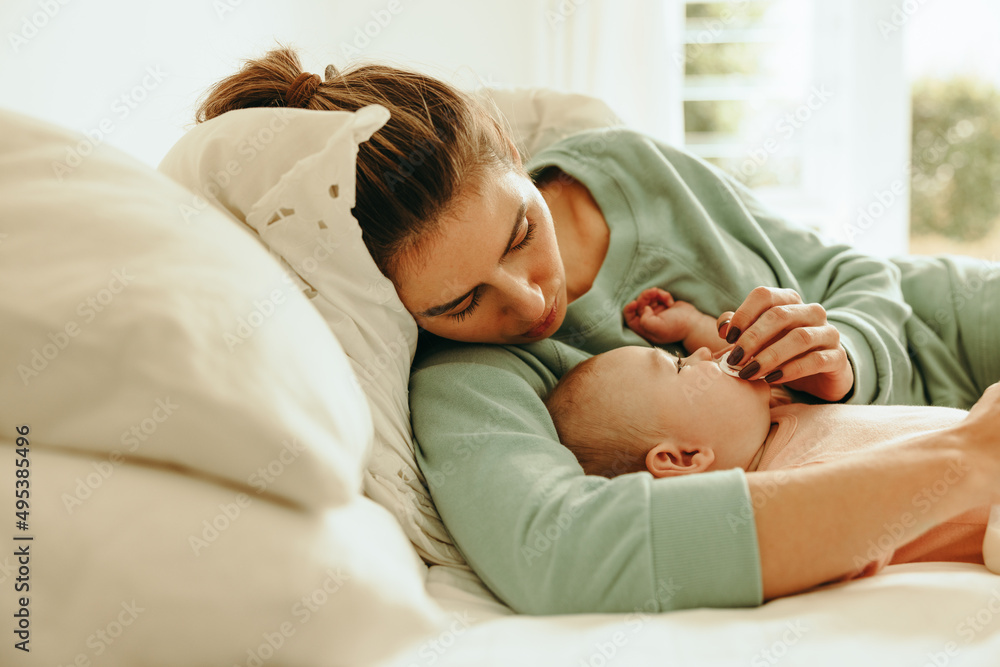 New mom giving her baby a dummy to suck on New mom giving her baby a dummy to suck on