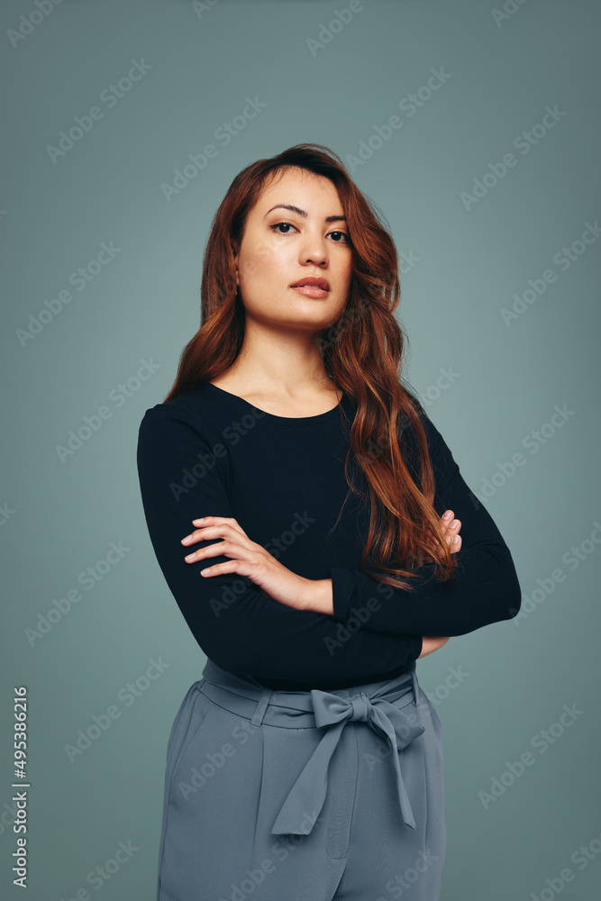 Strong independent young woman standing in a studio Strong independent young woman standing in a studio