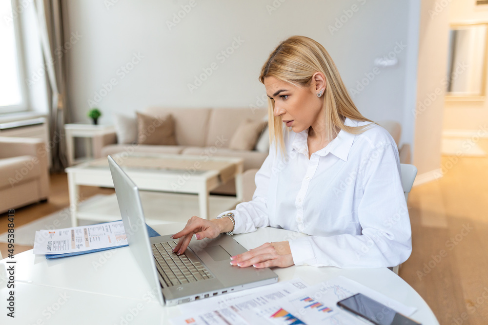 Remote job, technology and people concept - happy smiling young business woman with laptop computer and papers working at home office during the Covid-19 health crisis. Remote job, technology and people concept - happy smiling young business woman with laptop computer and papers working at home office during the Covid-19 health crisis.