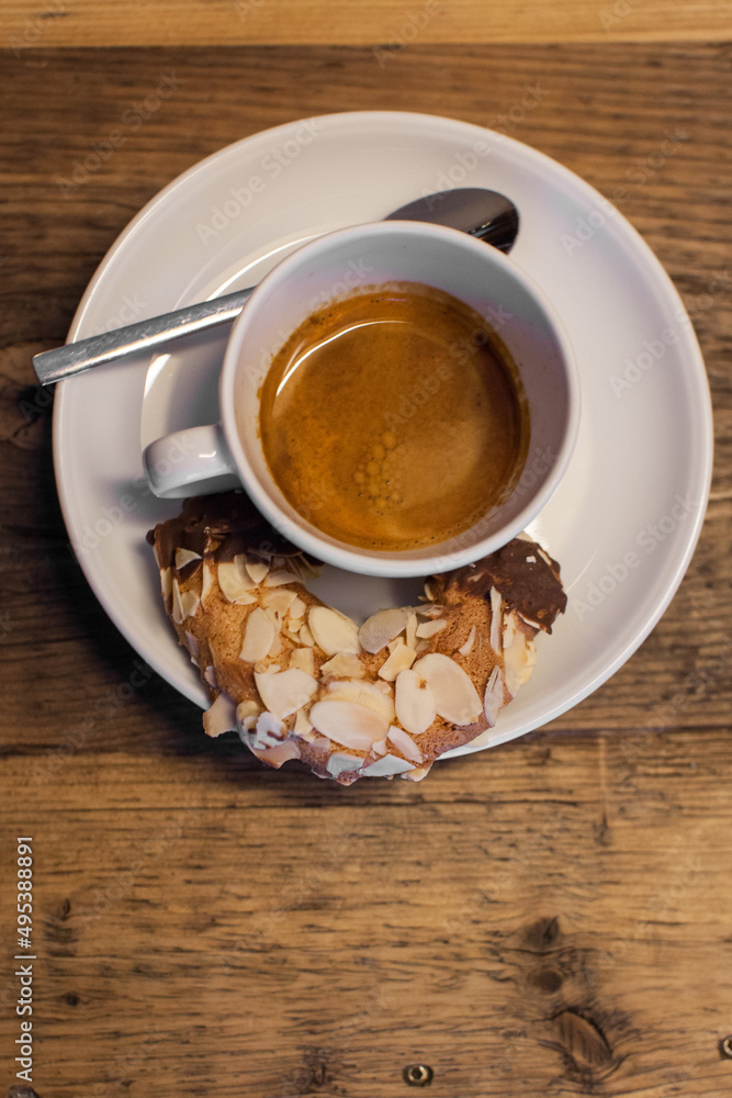 Obraz premium cup of coffee with a nut coated cookie 
