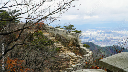 Bukhansanseong Fortress, the city, and the clouds in the sky.