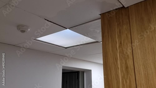 Water dripping from a wet ceiling in a modern staircase