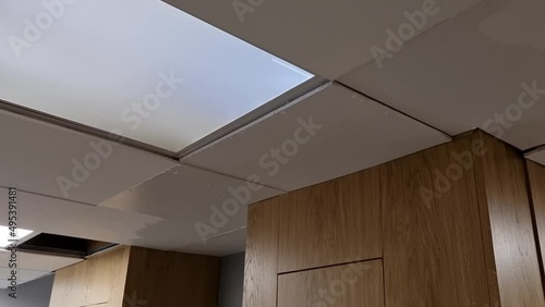 Water dripping from a wet ceiling in a modern staircase