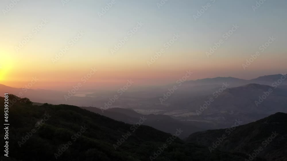 Foggy Sky Over Mountainscape During Sunset. Wide Shot over Lake Cachuma Santa Barbara Hills in California. Foggy Sky Over Mountainscape During Sunset. Wide Shot over Lake Cachuma Santa Barbara Hills in California.