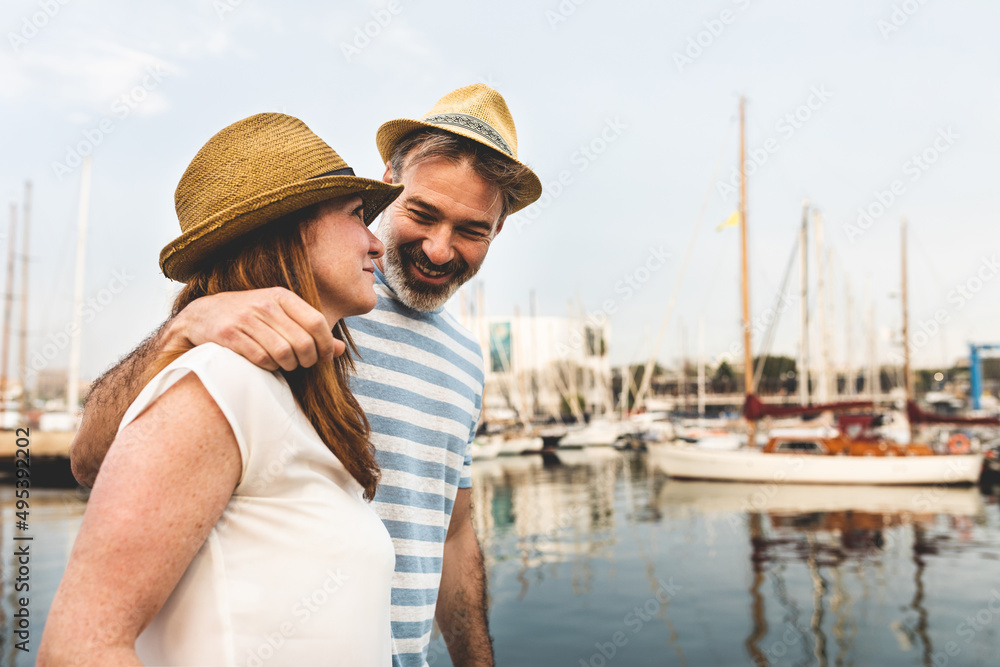 Happy adult couple portrait at the harbour in Barcelona