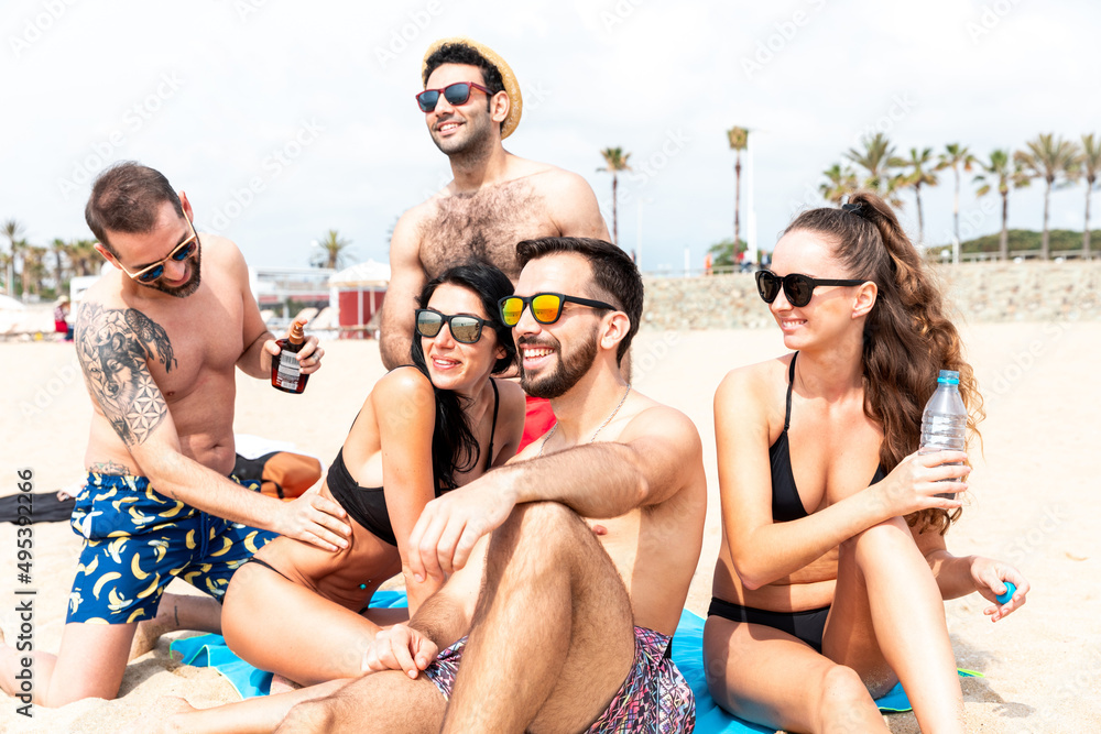 Happy people relaxing on the beach in Barcelona Happy people relaxing on the beach in Barcelona
