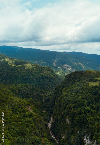 Okace canyon aerial view. The mountains are covered with green forest. Natural landscape. Vacation and Travel. Tourist place in Georgia. Vertical photo.