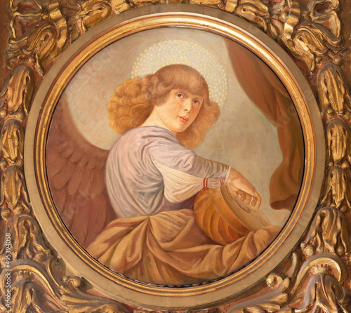 FORLÍ, ITALY - NOVEMBER 11, 2021: The fresco of angel with the guittar in the Cattedrala di Santa Croce after renaissance painter Melozzo da Forlí Giovanni by Secchi (1876 - 1950). photo