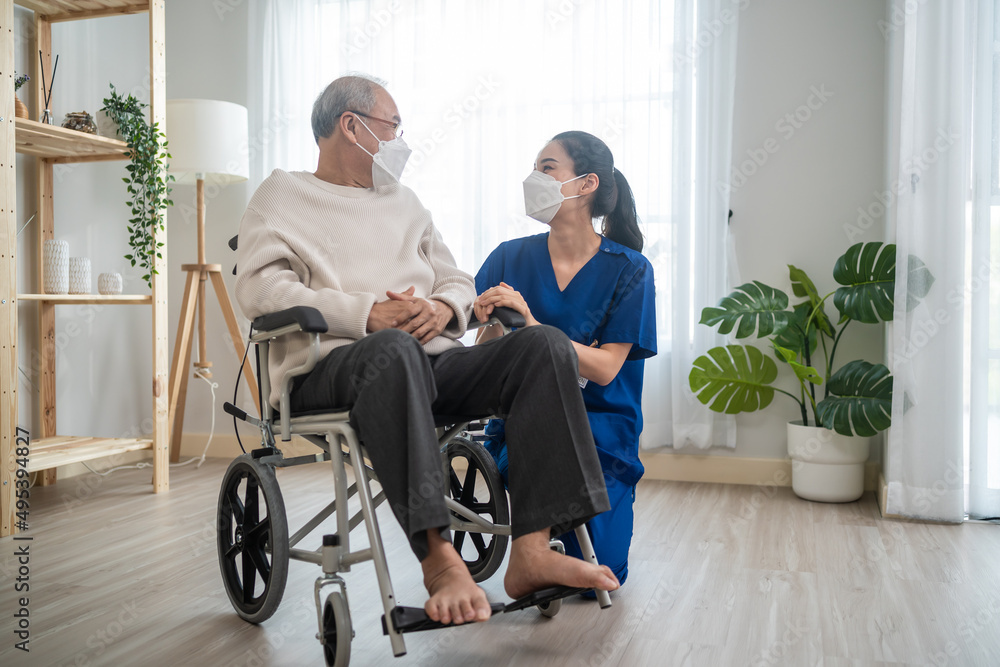 Portrait of Asian caregiver nurse take care senior male on wheelchair. 