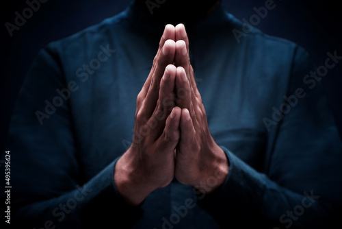 Muslim man greeting on dark background