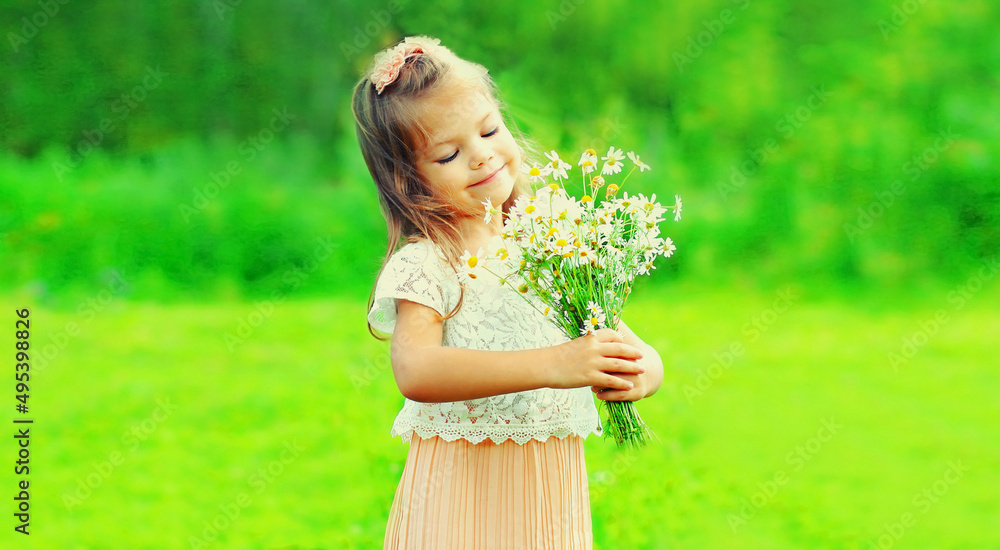 Portrait of cute little girl child with wildflowers in summer park Portrait of cute little girl child with wildflowers in summer park